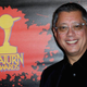 Dean Devlin smiling on the red carpet.